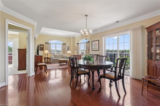 5414 Foundation St, Williamsburg, VA 23188 - dining space with dark wood-style flooring, a chandelier, ornamental molding, and baseboards