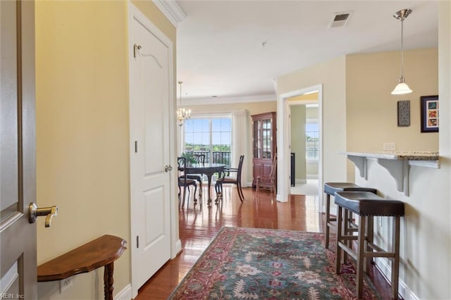 5414 Foundation St, Williamsburg, VA 23188 - hall featuring dark wood-type flooring, a chandelier, crown molding, and baseboards