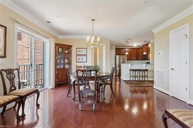 5414 Foundation St, Williamsburg, VA 23188 - dining space featuring a chandelier, dark wood finished floors, ornamental molding, and baseboards