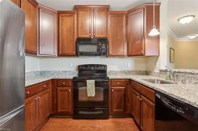 5414 Foundation St, Williamsburg, VA 23188 - kitchen featuring black appliances, a sink, crown molding, light stone countertops, and light wood finished floors