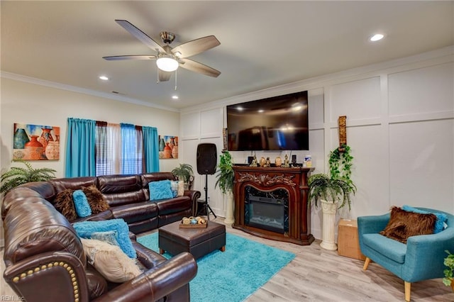 101 Utah St, Portsmouth, VA 23701 - living room with crown molding, a ceiling fan, light wood-style flooring, recessed lighting, and a glass covered fireplace