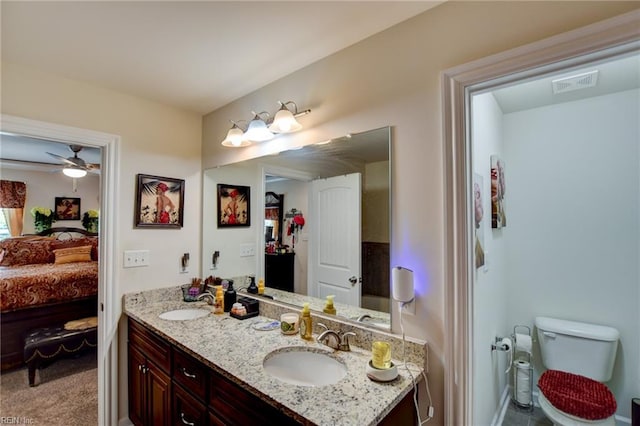 101 Utah St, Portsmouth, VA 23701 - ensuite bathroom featuring toilet, double vanity, a ceiling fan, and baseboards