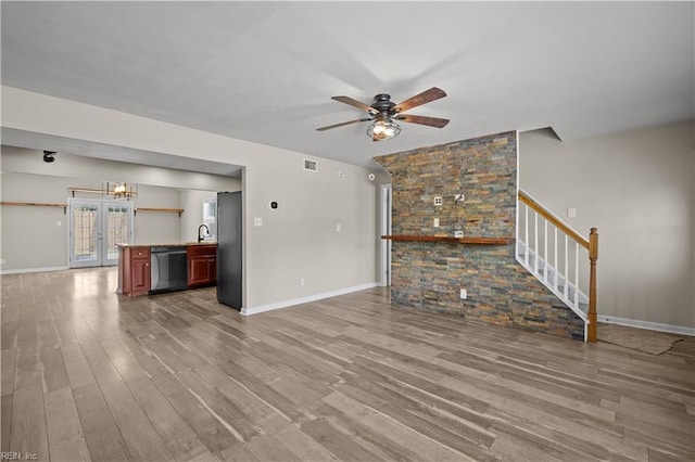 6304 Ball Ave, Norfolk, VA 23518 - unfurnished living room with wood finished floors, ceiling fan, stairway, and baseboards