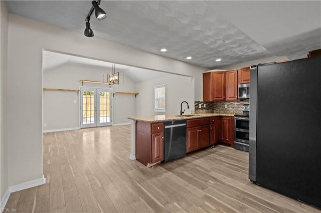 6304 Ball Ave, Norfolk, VA 23518 - kitchen featuring appliances with stainless steel finishes, a sink, baseboards, light wood-type flooring, and vaulted ceiling