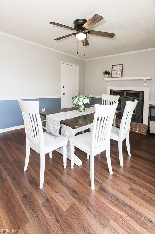 1 Lake Walk Xing, Hampton, VA 23666 - dining area featuring a ceiling fan, wood finished floors, ornamental molding, a fireplace with raised hearth, and baseboards