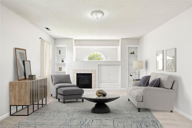 405 Millwright Way, Chesapeake, VA 23323 - living room featuring a textured ceiling, built in features, carpet flooring, a fireplace, and baseboards