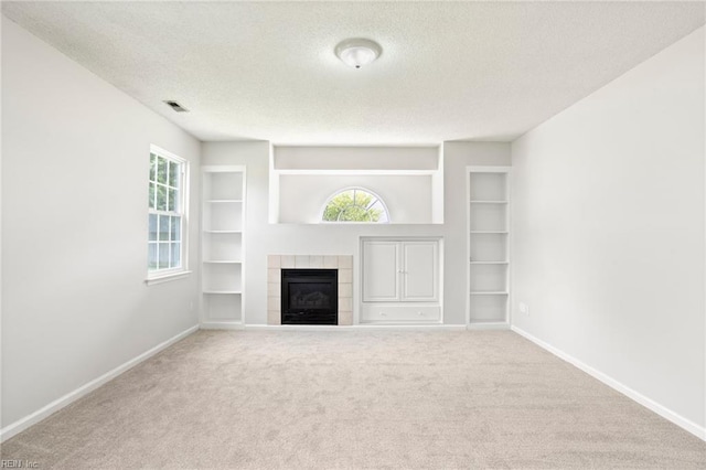 405 Millwright Way, Chesapeake, VA 23323 - unfurnished living room with a textured ceiling, built in features, carpet floors, and plenty of natural light