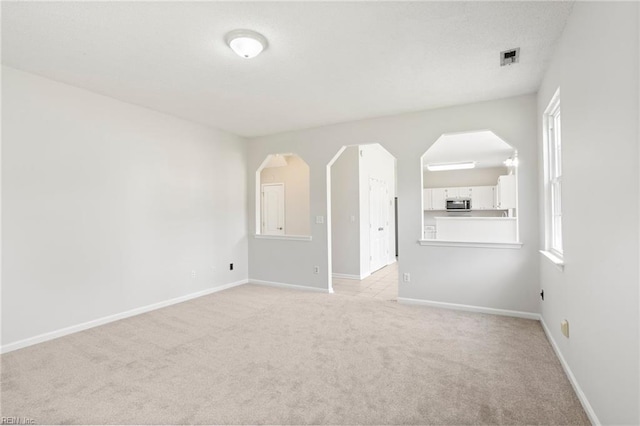 405 Millwright Way, Chesapeake, VA 23323 - unfurnished living room with light colored carpet, arched walkways, and baseboards