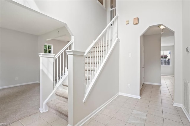 405 Millwright Way, Chesapeake, VA 23323 - stairway featuring plenty of natural light, arched walkways, tile patterned flooring, baseboards, and a towering ceiling