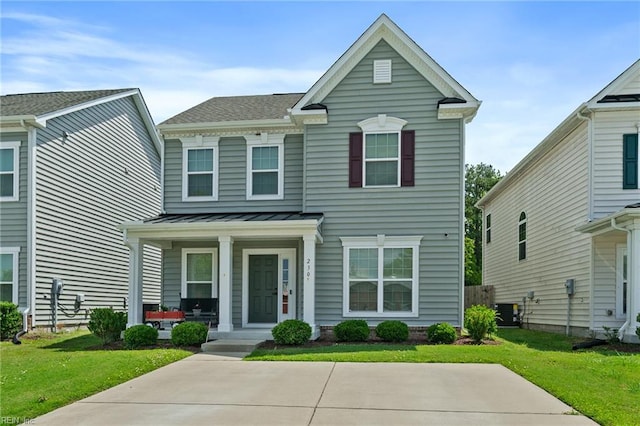 230 Independence St, Portsmouth, VA 23701 - view of front of house featuring covered porch, a front lawn, central air condition unit, a standing seam roof, and roof with shingles