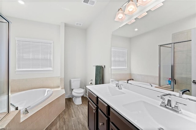 230 Independence St, Portsmouth, VA 23701 - bathroom with a bath, toilet, wood finished floors, double vanity, and recessed lighting