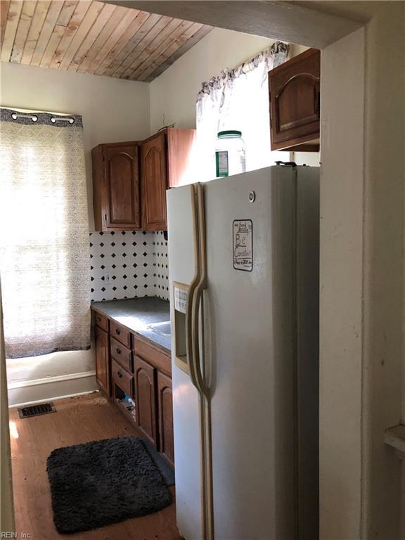 3122 Cape Henry Ave, Norfolk, VA 23509 - kitchen with white refrigerator with ice dispenser, wooden ceiling, wood finished floors, and brown cabinets