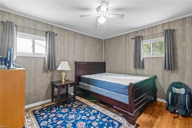 8332 Halprin Dr, Norfolk, VA 23518 - bedroom with wood finished floors, baseboards, ceiling fan, and wood walls