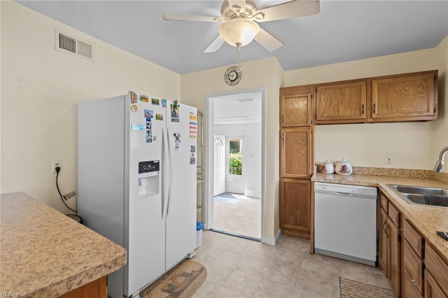 8332 Halprin Dr, Norfolk, VA 23518 - kitchen with white appliances, a sink, brown cabinets, and light countertops
