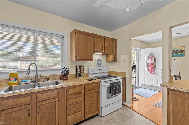 8332 Halprin Dr, Norfolk, VA 23518 - kitchen with white range with electric cooktop, a sink, light countertops, and brown cabinets