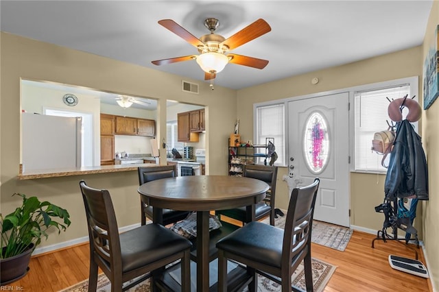 8332 Halprin Dr, Norfolk, VA 23518 - dining room featuring a ceiling fan, light wood-style flooring, and baseboards