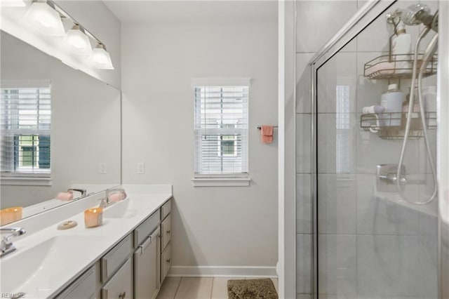 full bathroom featuring healthy amount of natural light, a shower stall, tile patterned flooring, and double vanity