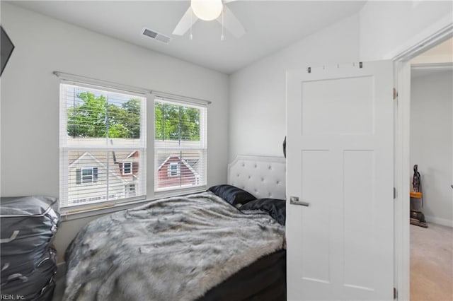 bedroom featuring vaulted ceiling, light colored carpet, a ceiling fan, and baseboards