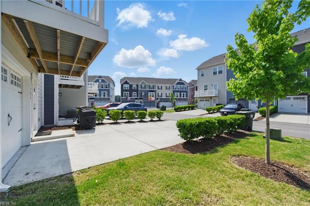 view of green lawn with a residential view