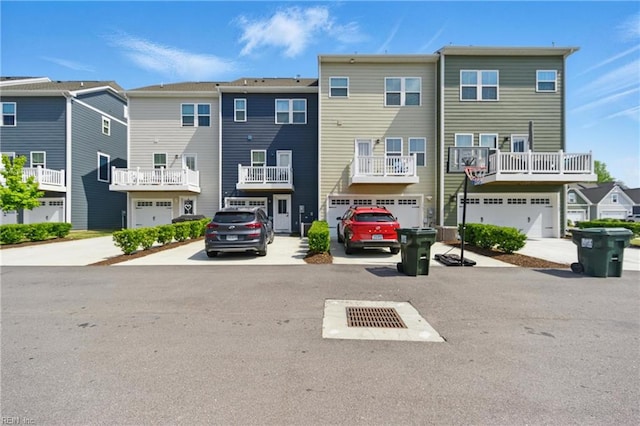 back of property featuring a garage, driveway, and a residential view