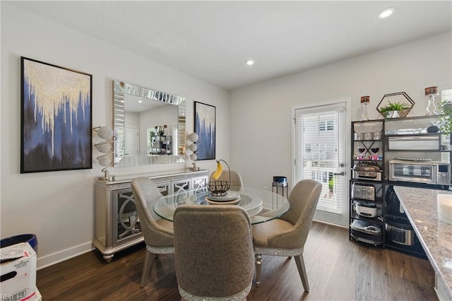 dining space featuring dark wood-style floors, baseboards, and recessed lighting