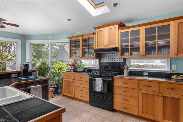 6052 Newport Cres, Norfolk, VA 23505 - kitchen featuring black gas stove, under cabinet range hood, plenty of natural light, a skylight, and recessed lighting