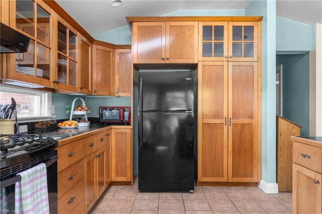 6052 Newport Cres, Norfolk, VA 23505 - kitchen featuring black appliances, lofted ceiling, dark countertops, glass insert cabinets, and under cabinet range hood