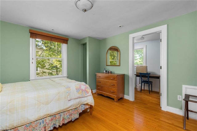 6052 Newport Cres, Norfolk, VA 23505 - bedroom with multiple windows, light wood finished floors, and baseboards