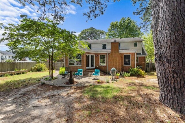 6052 Newport Cres, Norfolk, VA 23505 - rear view of house with brick siding, a fenced backyard, and a patio area