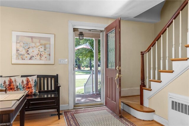 6052 Newport Cres, Norfolk, VA 23505 - entryway with radiator heating unit, wood finished floors, baseboards, and stairway
