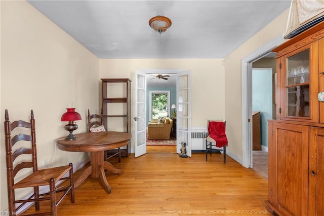 6052 Newport Cres, Norfolk, VA 23505 - living area featuring light wood-type flooring, french doors, ceiling fan, baseboards, and radiator heating unit