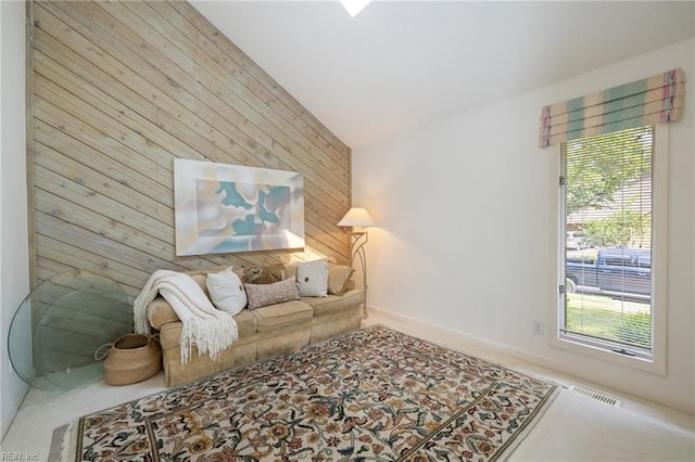 4401 Leatherwood Dr, Virginia Beach, VA 23462 - carpeted living area featuring lofted ceiling, wooden walls, healthy amount of natural light, and baseboards