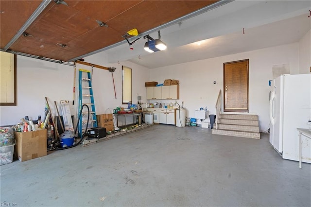 4401 Leatherwood Dr, Virginia Beach, VA 23462 - garage with freestanding refrigerator, a garage door opener, and a sink