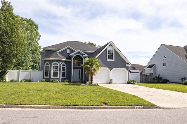 1660 Chestwood Dr, Virginia Beach, VA 23453 - traditional-style house with concrete driveway, a garage, and stucco siding