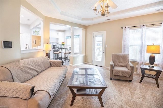 1660 Chestwood Dr, Virginia Beach, VA 23453 - living room featuring carpet flooring, plenty of natural light, decorative columns, a tray ceiling, and a textured ceiling