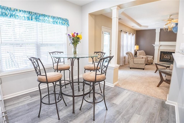 1660 Chestwood Dr, Virginia Beach, VA 23453 - dining area featuring decorative columns, a ceiling fan, wood finished floors, a fireplace, and baseboards