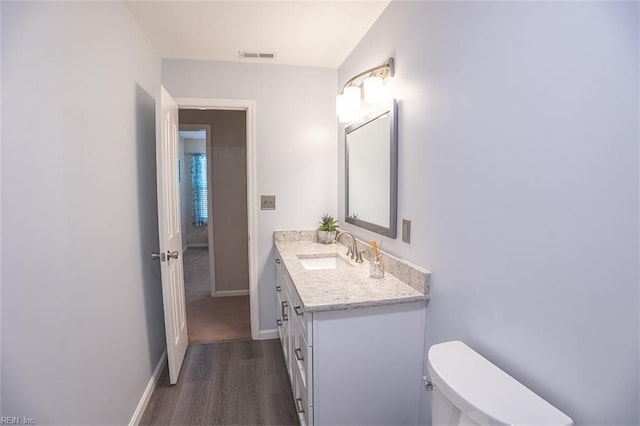 1660 Chestwood Dr, Virginia Beach, VA 23453 - half bath with vanity, wood finished floors, baseboards, and toilet
