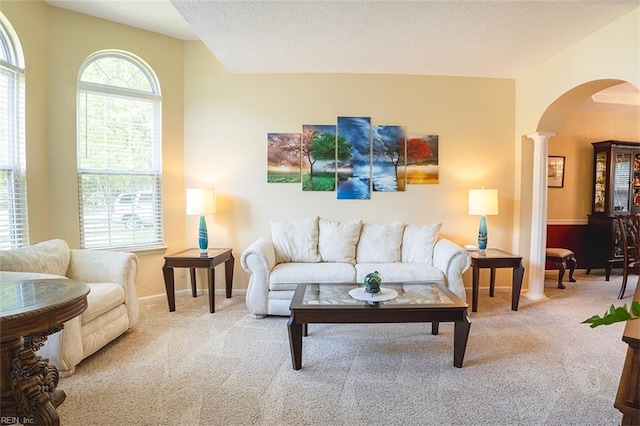 1660 Chestwood Dr, Virginia Beach, VA 23453 - carpeted living room featuring arched walkways, ornate columns, and baseboards