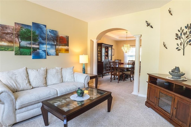 1660 Chestwood Dr, Virginia Beach, VA 23453 - living room featuring arched walkways, ornate columns, light carpet, and a chandelier