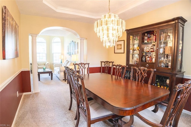 1660 Chestwood Dr, Virginia Beach, VA 23453 - dining area featuring ornate columns, arched walkways, light colored carpet, a raised ceiling, and a chandelier