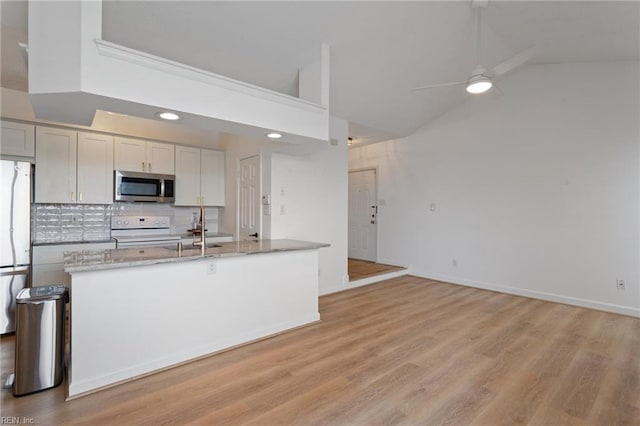 3200 Jade Ct Unit 301, Virginia Beach, VA 23451 - kitchen with stainless steel microwave, white range with electric cooktop, a ceiling fan, tasteful backsplash, and light stone counters