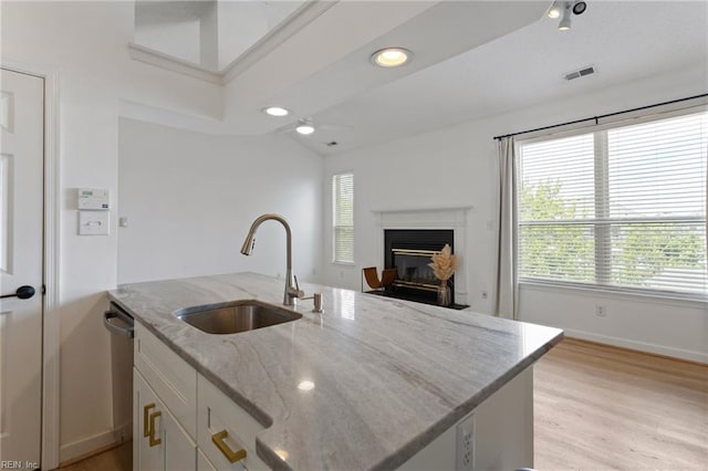 3200 Jade Ct Unit 301, Virginia Beach, VA 23451 - kitchen with a sink, stainless steel dishwasher, baseboards, white cabinets, and light wood-type flooring
