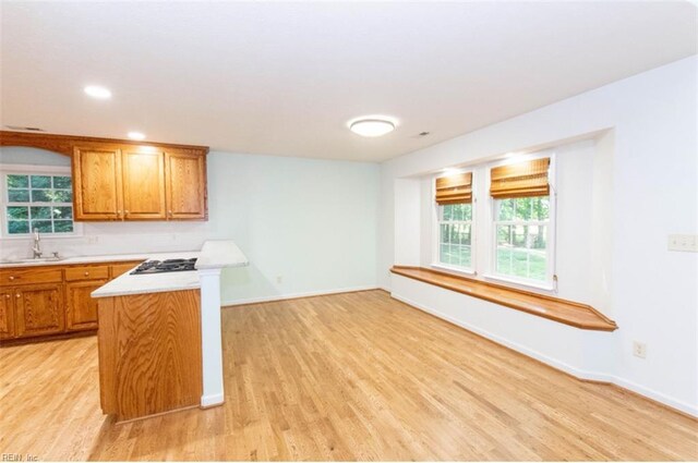 505 Plantation Rd, North, VA 23128 - kitchen featuring light wood finished floors, light countertops, brown cabinets, baseboards, and recessed lighting