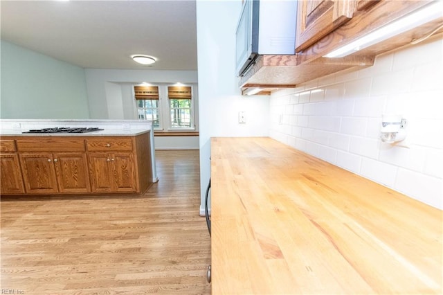 505 Plantation Rd, North, VA 23128 - kitchen featuring light wood-style flooring, brown cabinetry, gas stovetop, and tasteful backsplash