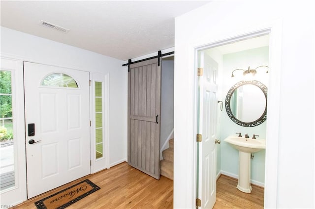 505 Plantation Rd, North, VA 23128 - entryway with a barn door, light wood-style flooring, stairway, and baseboards