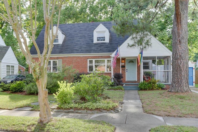 7811 Michael Dr, Norfolk, VA 23505 - cape cod house with brick siding, covered porch, and roof with shingles