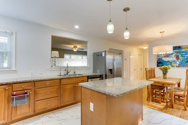 7811 Michael Dr, Norfolk, VA 23505 - kitchen with appliances with stainless steel finishes, a sink, light marble finish flooring, light stone counters, and brown cabinets