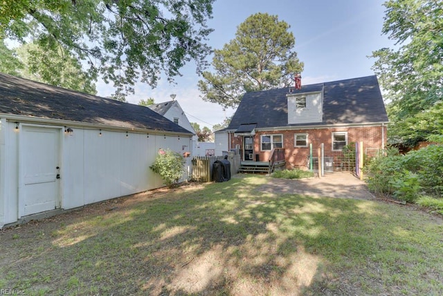 7811 Michael Dr, Norfolk, VA 23505 - back of property with a yard, a wooden deck, and brick siding