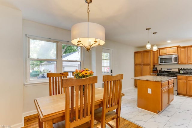 7811 Michael Dr, Norfolk, VA 23505 - kitchen featuring appliances with stainless steel finishes, a chandelier, healthy amount of natural light, a kitchen island, and recessed lighting