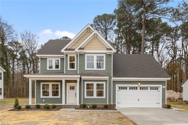 MM SC, Chesapeake, VA 23322 - view of front facade featuring concrete driveway, an attached garage, roof with shingles, and covered porch